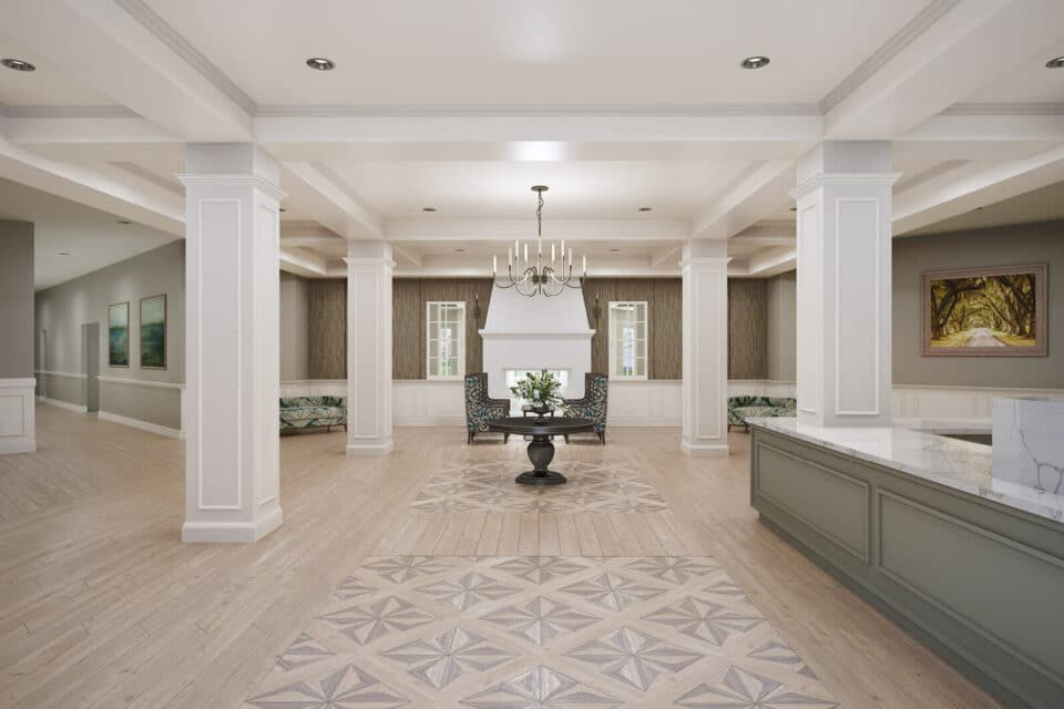 3D digital rendering of the lobby including light wood floors, white wooden columns, white see through fireplace at back of room, two chairs, and table in center, two couches on each side, white marble countertops at lobby desk with painting of trees hanging on wall at right and a hallway view at left.