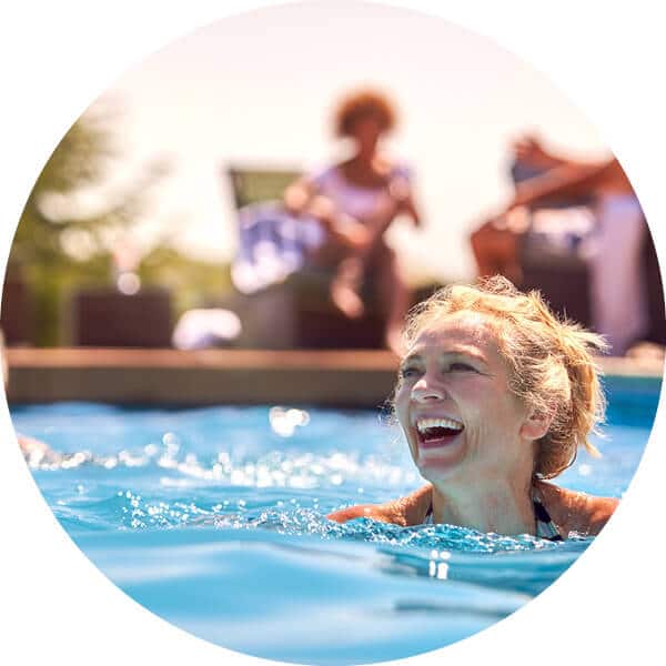Close up view of woman smiling and swimming in pool